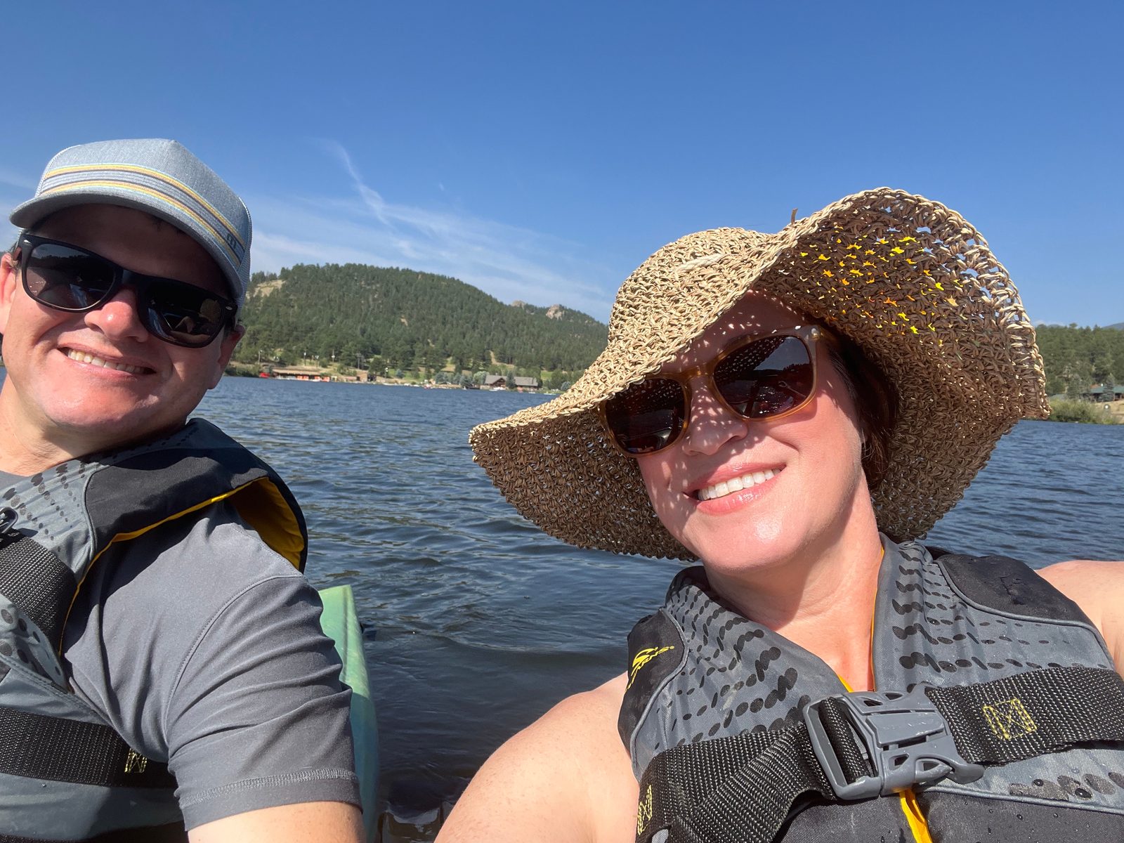 Julie and Jay kayaking on a mountain lake