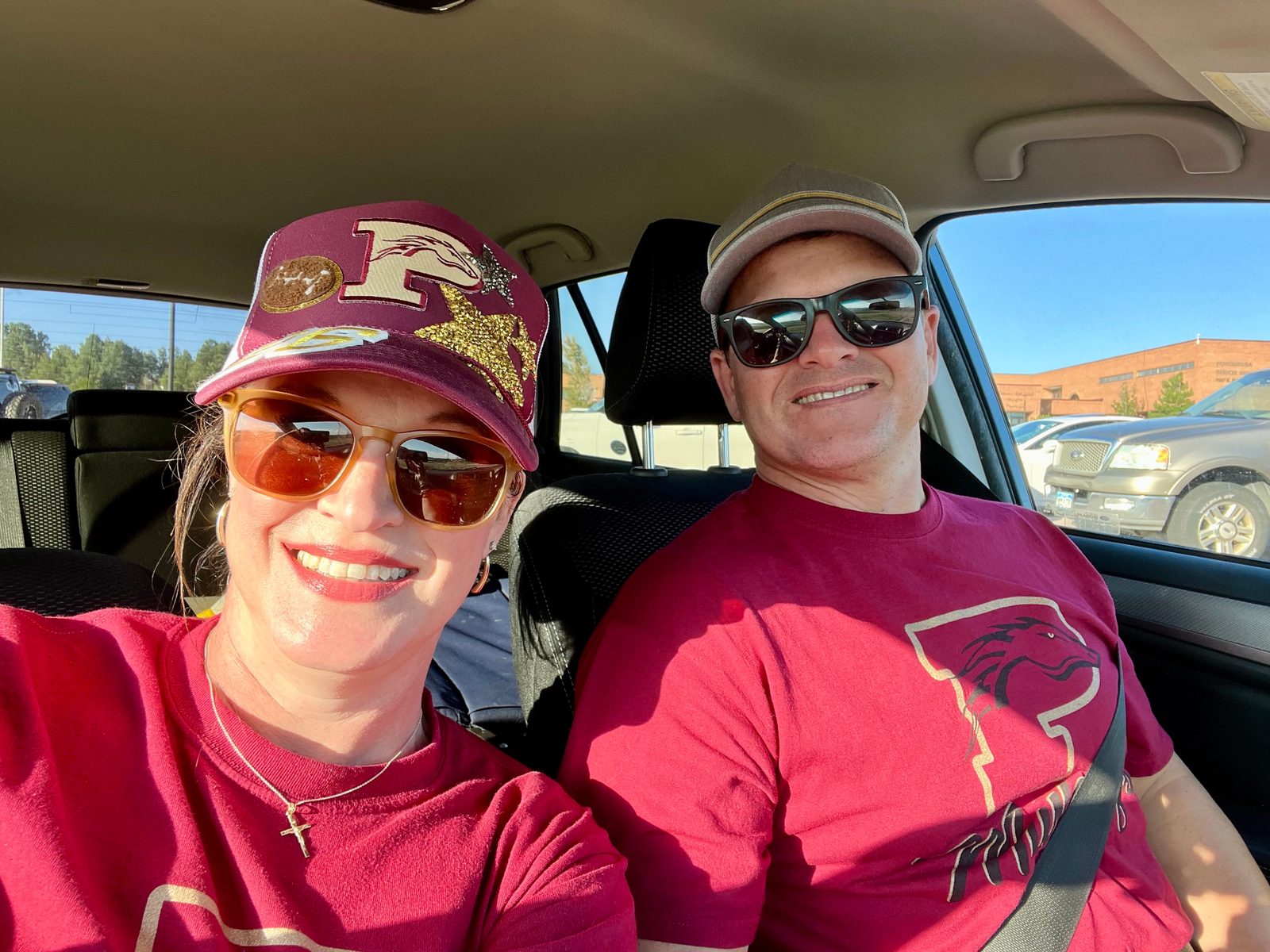 Julie and Jay in maroon apparel before a game