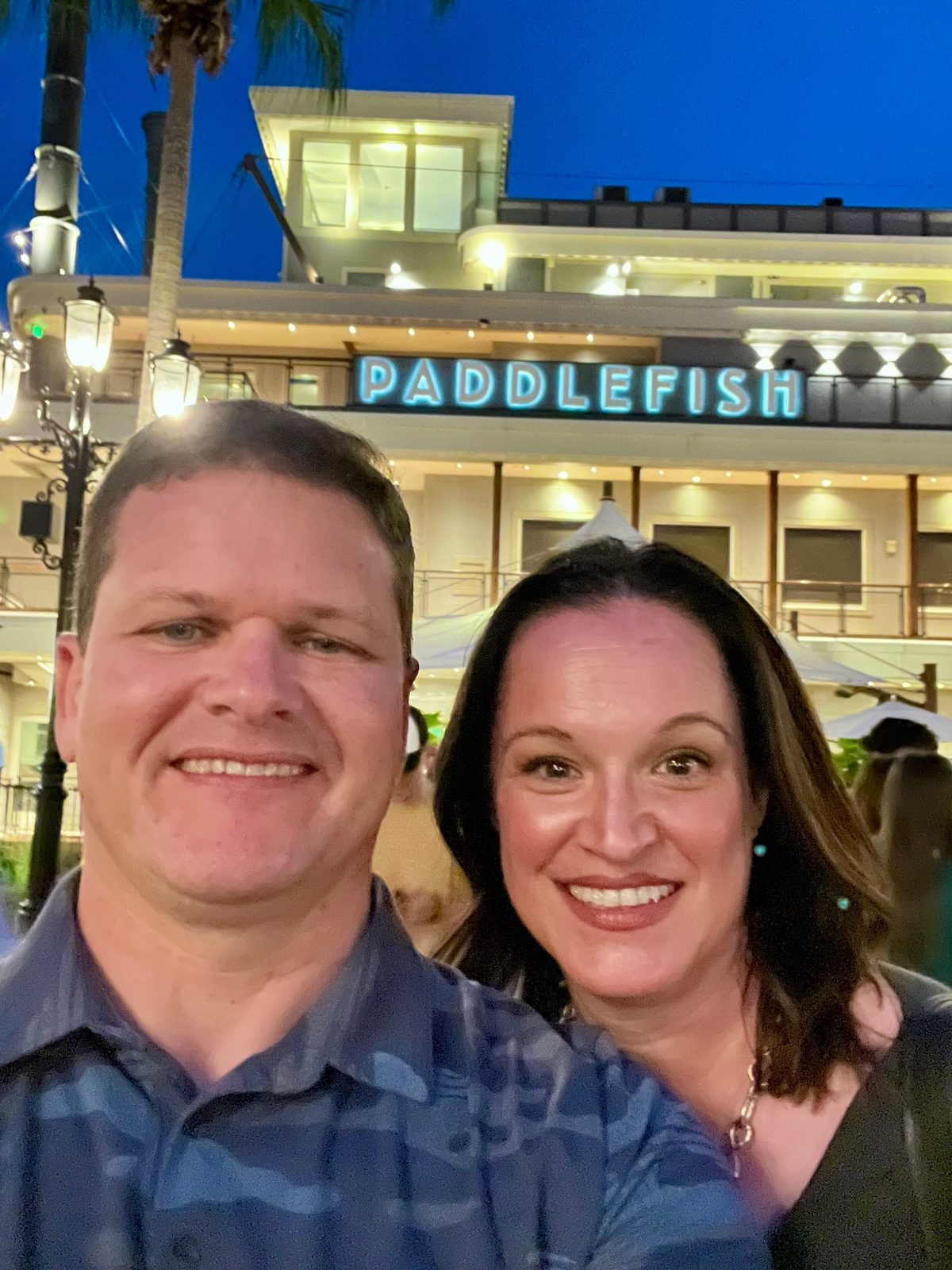 Julie and Jay in front of the Paddlefish at night