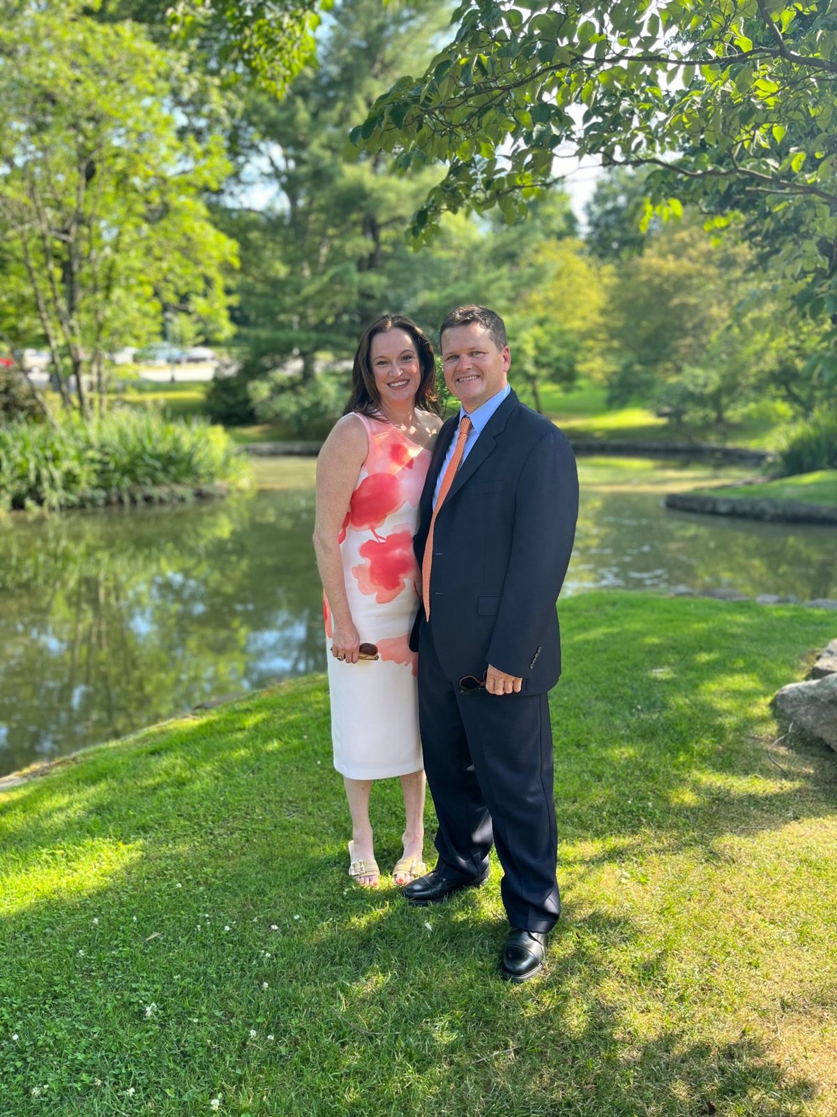 Julie and Jay by a pond in summer